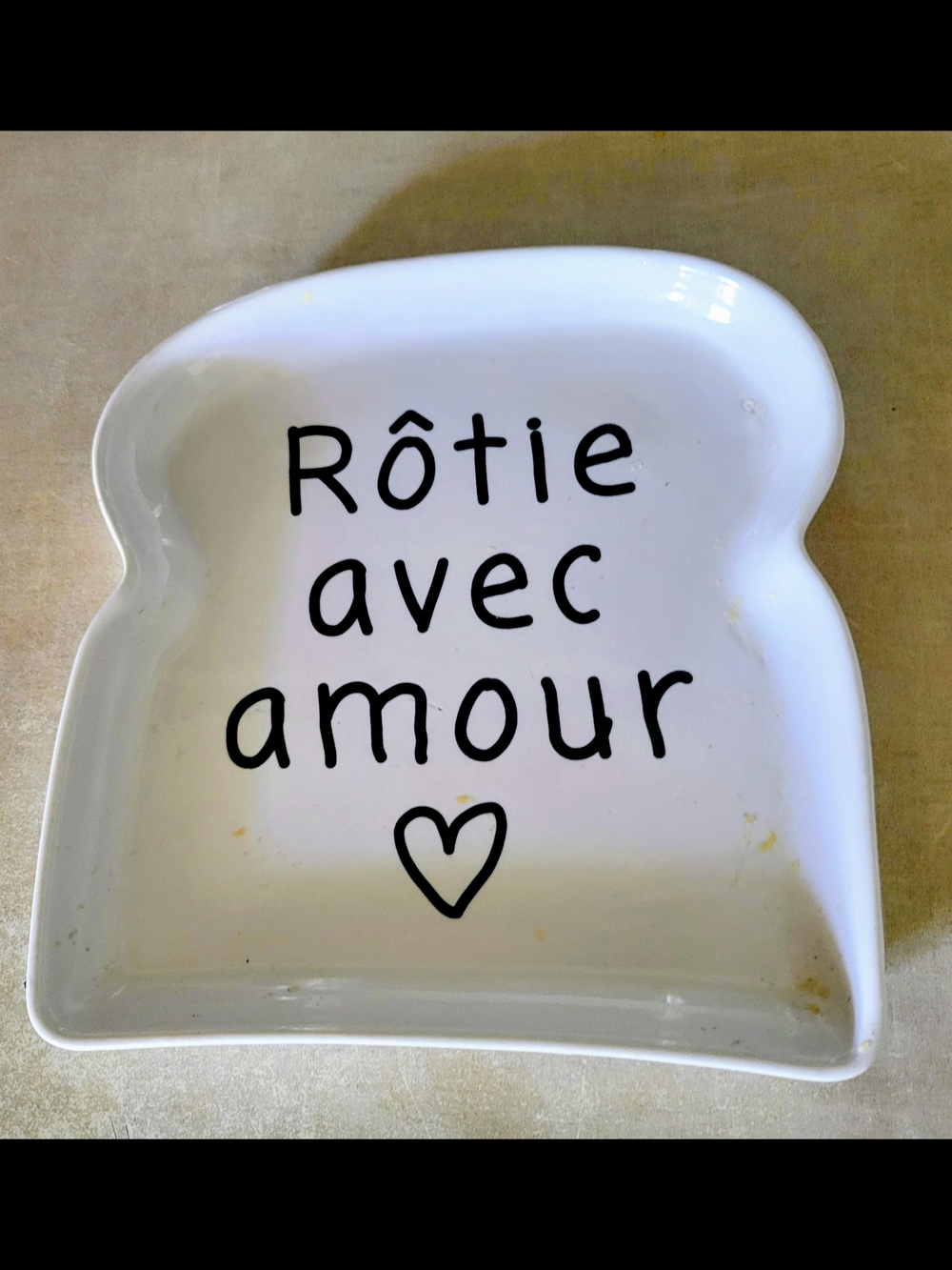 White Ceramic Toast-Shaped Dish with 'Rôtie avec amour'.